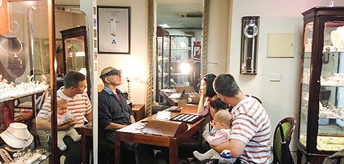 Inside the Bunda Street studio: clients at the design table among the display cabinets