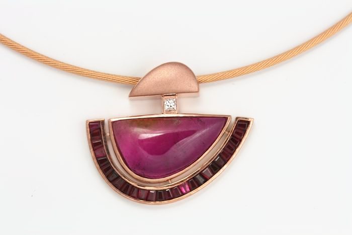 Rubellite half-moon pendant: a Rubellite Tourmaline with Rubies in 18 karat rose gold