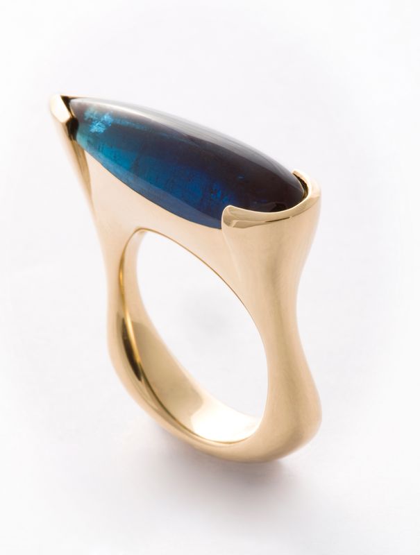 A sculpted yellow gold ring with a long blue-green tourmaline cabochon