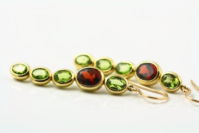 Peridot line earrings: Peridots and Garnets set in 18 karat yellow gold