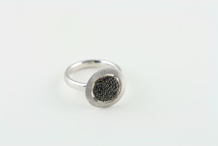 Black diamond disc ring: black diamonds set in 18 karat white gold