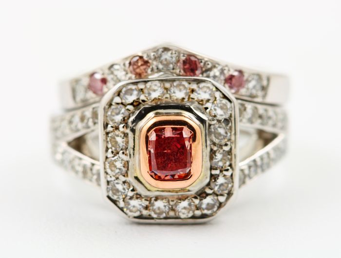 Pink diamond halo ring: a natural pink diamond with diamonds in 18 karat white gold