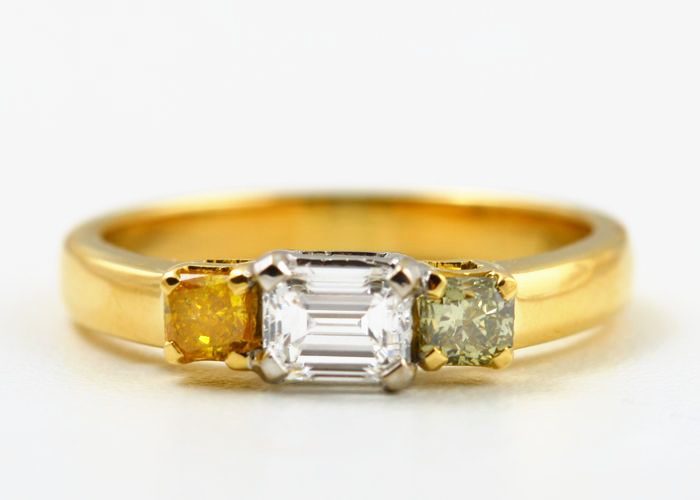 Yellow diamond trilogy ring: yellow and colourless diamonds set in 18 karat yellow gold