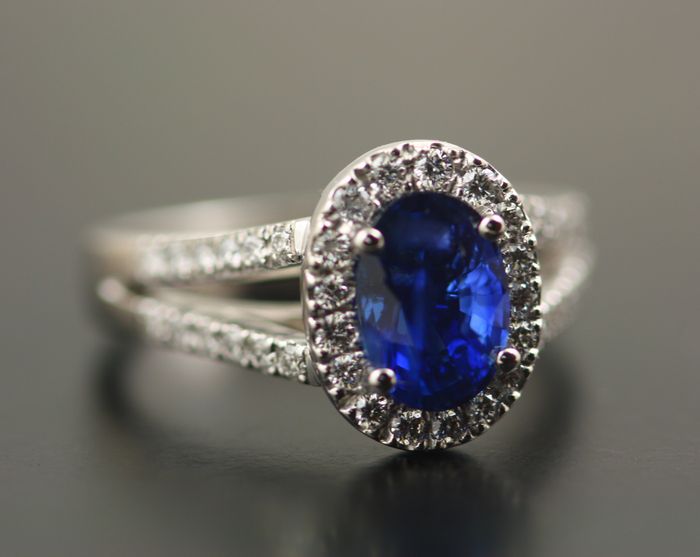 Sapphire halo and split band ring: a deep blue Sapphire set in 18 karat white gold surrounded in a halo of diamonds in 18 karat white gold