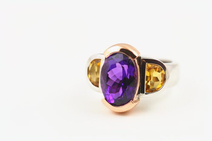 Amethyst three-stone ring: an Amethyst with Citrines in 18 karat rose and white gold