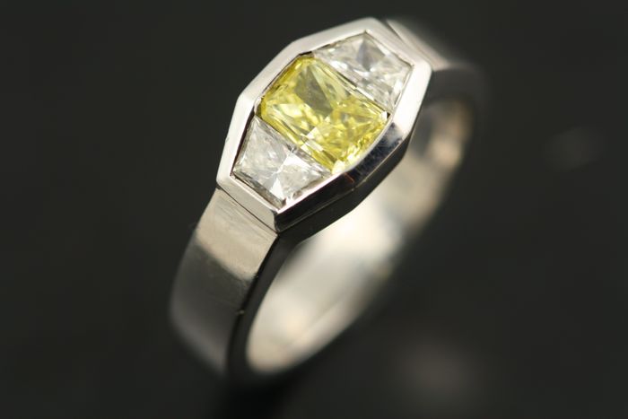 Fancy yellow diamond ring: a yellow diamond with diamonds in 18 karat white gold