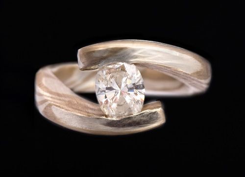 Crossover ring: a diamond in a Mokume Gane crossover ring made from 18 karat white gold and silver