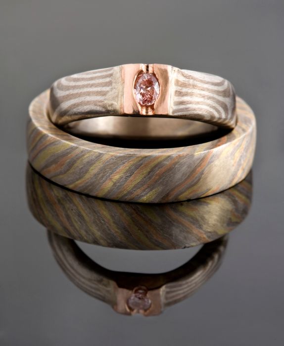 Pair of Mokume Gane rings: a pair of Mokume Gane rings with a pink diamond