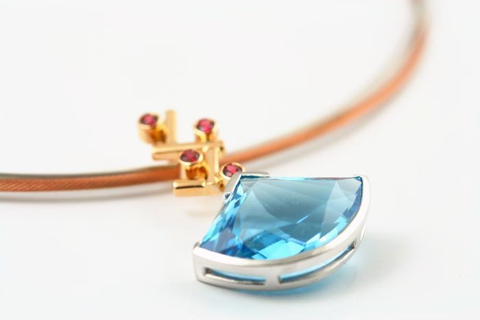 Topaz fan pendant: a blue Topaz set in 18 karat gold