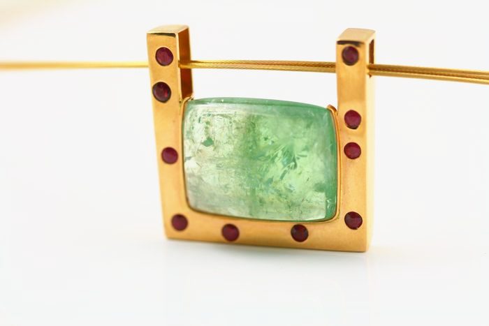 Tourmaline frame pendant: a green Tourmaline with Rubies in 18 karat yellow gold