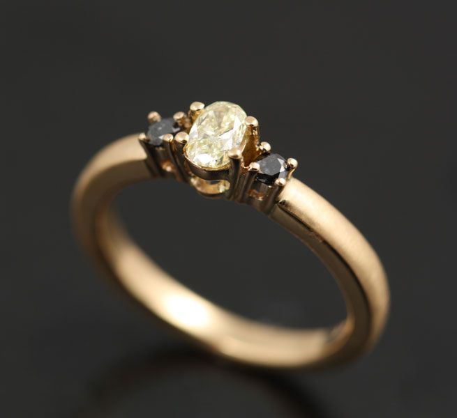Yellow diamond ring: a yellow diamond with black diamonds in 18 karat rose gold