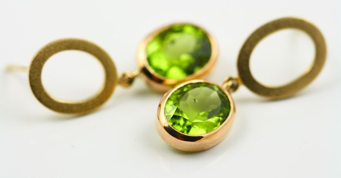 Peridot disc earrings: Peridots set in 18 karat yellow gold