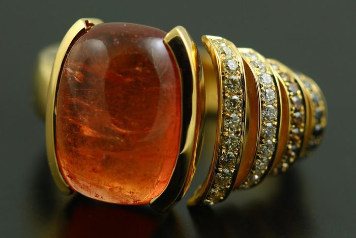 Mandarin Garnet cabochon ring: a Mandarin Garnet with diamonds in 18 karat yellow gold
