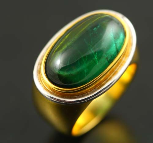 Tourmaline cabochon ring: a green Tourmaline set in 18 karat yellow gold