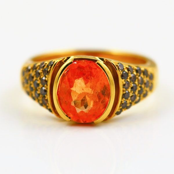 Mandarin Garnet and black diamond ring: a Mandarin Garnet with black diamonds in 18 karat yellow gold