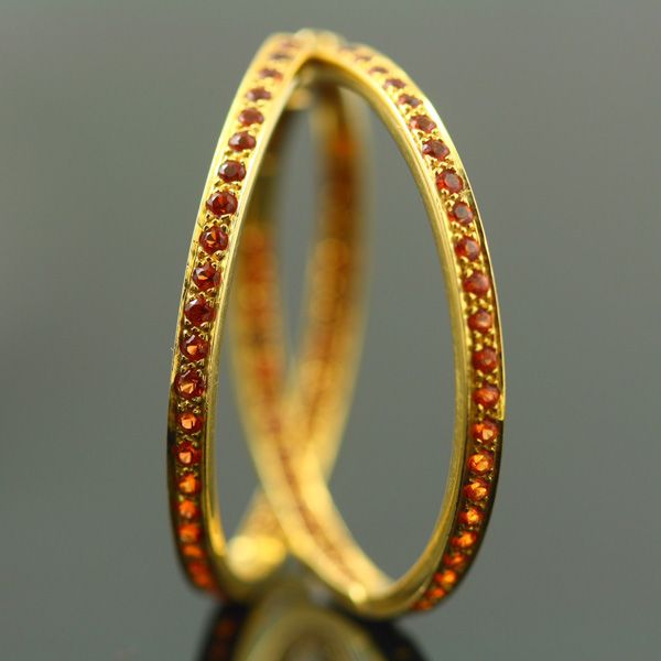 Sapphire crossover ring: orange Sapphires set in 18 karat yellow gold