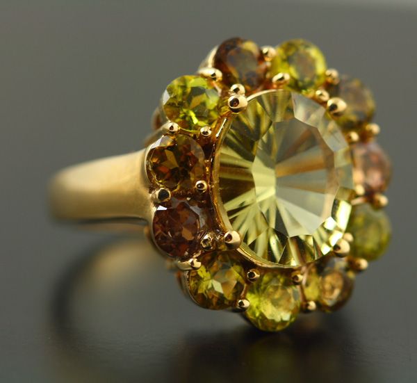 Lemon Quartz cluster ring: a Lemon Quartz with Peridots in 18 karat yellow gold